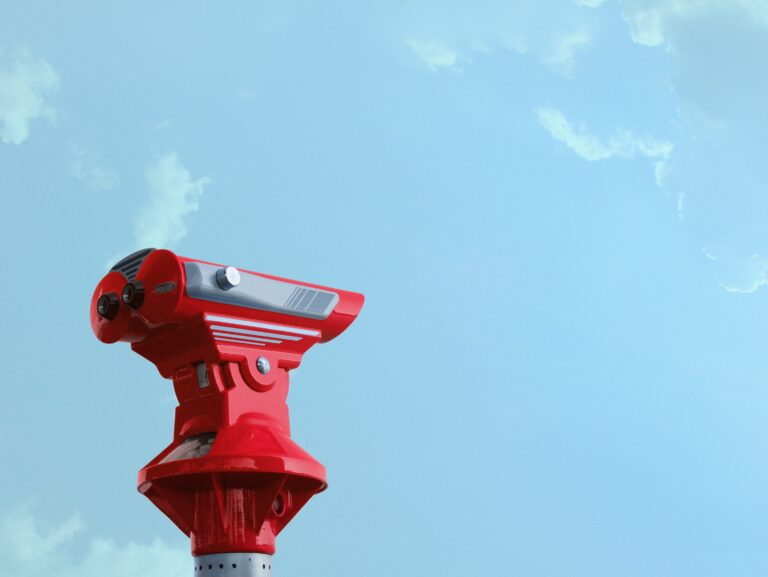 Binoculars pointing at the blue sky