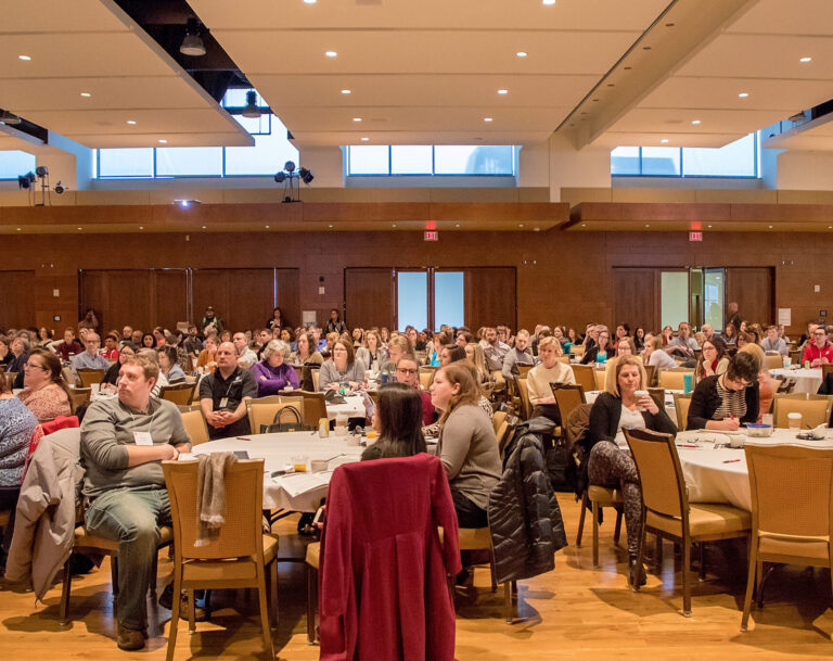 Career conference attendees listen to a presentation